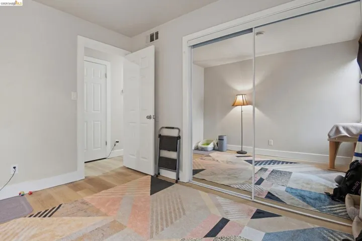 Bedroom with light wood-style floors and a closet