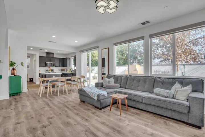 Living room with light wood-style floors and recessed lighting