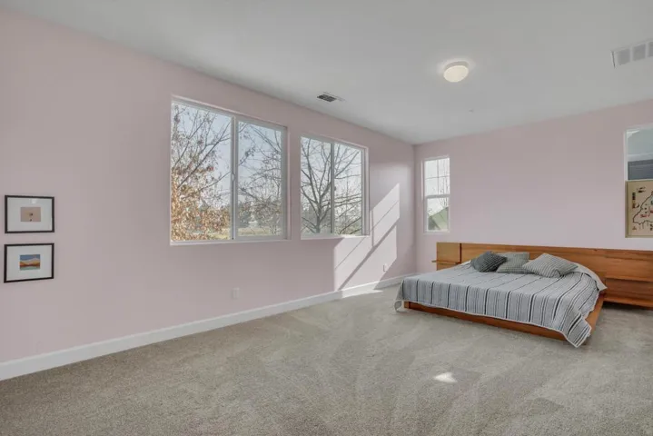 Bedroom featuring carpet floors and baseboards
