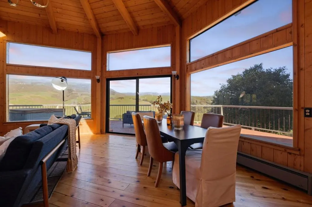 Main house living and dining area - wall of windows brings is ample natural light