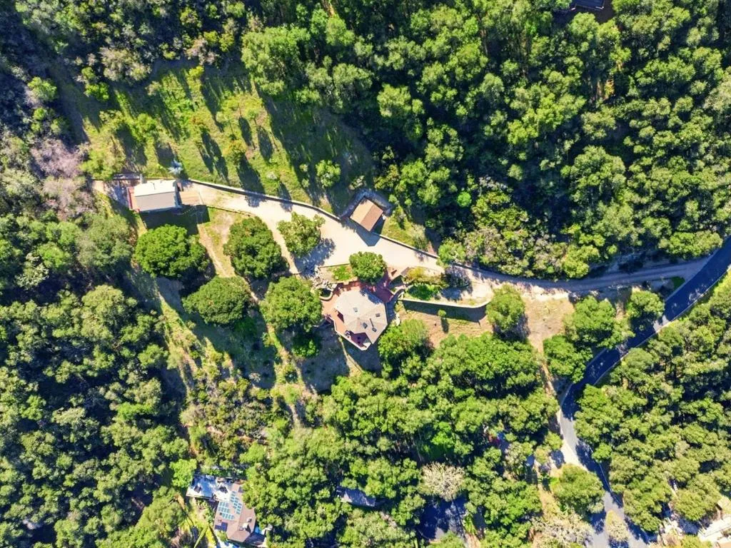 The property is flanked with trees and greenery while being situated in a Firewise community.