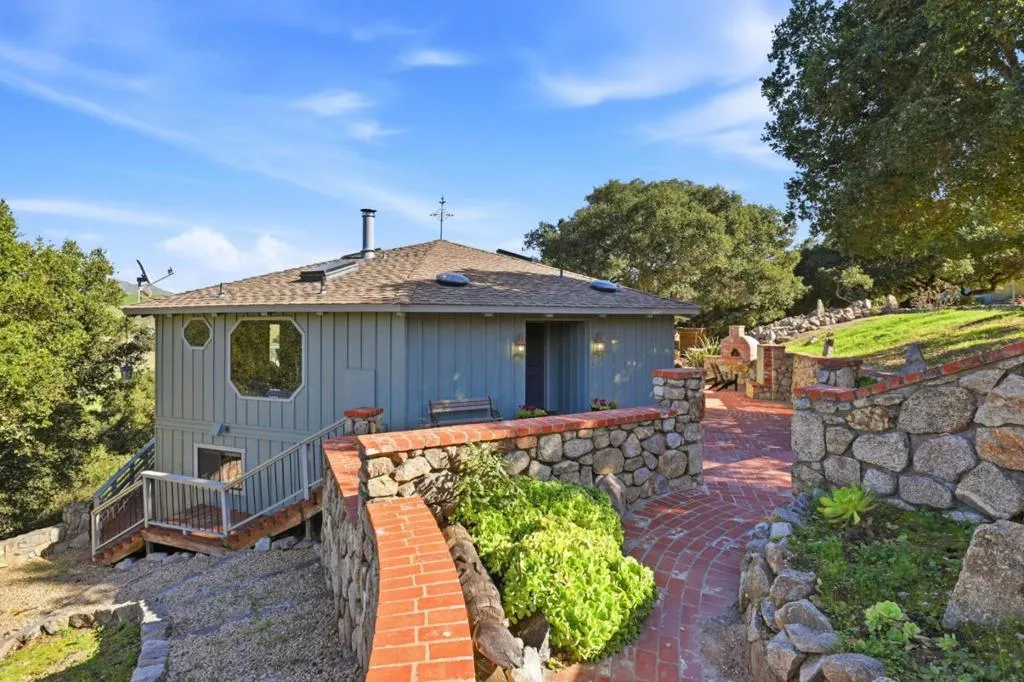 Main house entry with view to lower level access path plus stairs