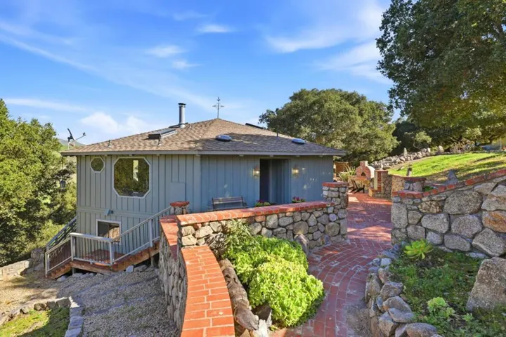 Main house entry with view to lower level access path plus stairs