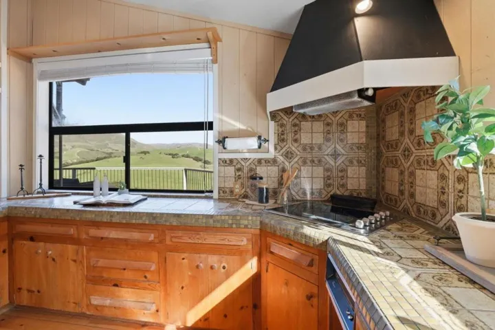 Main home kitchen, with spectacular views of the hills/mountains beyond