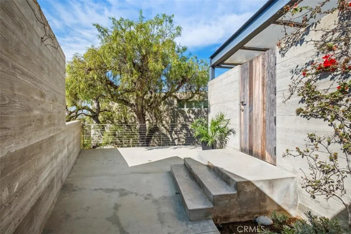 One door from inside carport enters to stairway for house.