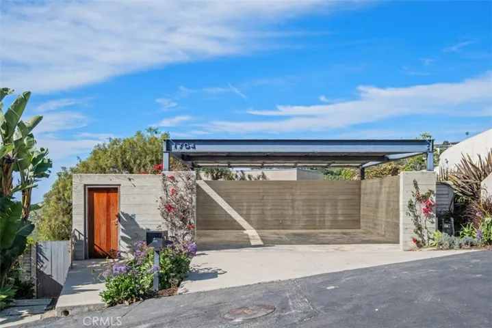 Carport has concrete walls, three doors from street level access the property.