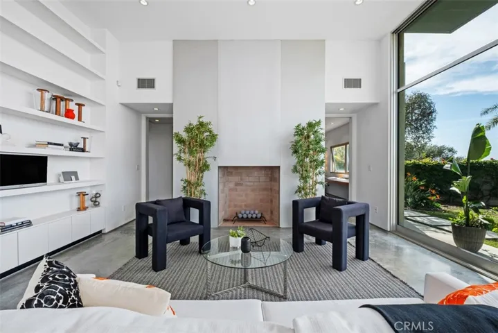 There are built-in storage cabinets on both sides of the fireplace.