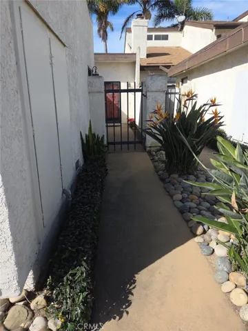Walkway leading to the entrance and courtyard/patio area.
