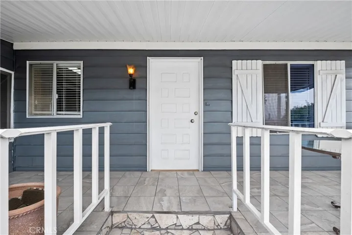 Front door opens to living room with big windows to enjoy the sunsets