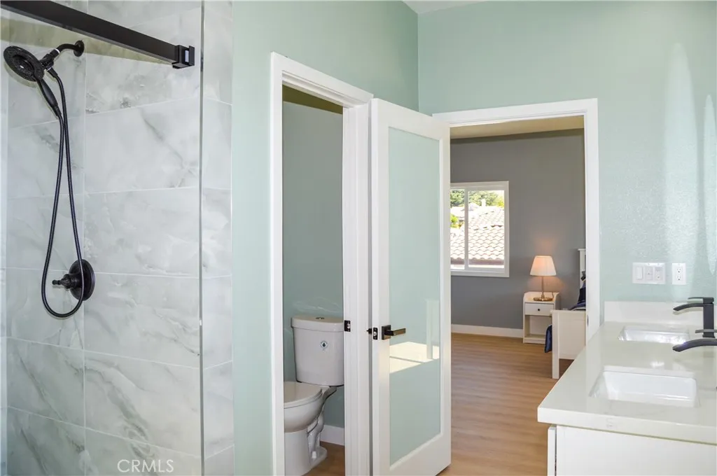 Unit 1 - Main Suite Bath with Dual Sinks, Lighted Mirrors, Walk-in Shower with Custom Tile, and Private Water Closet