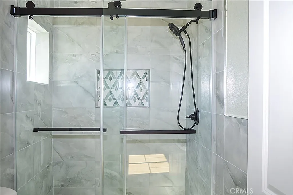Unit 2 - Main Suite Bath with glass-enclosed shower, lighted mirror and even a view from the shower