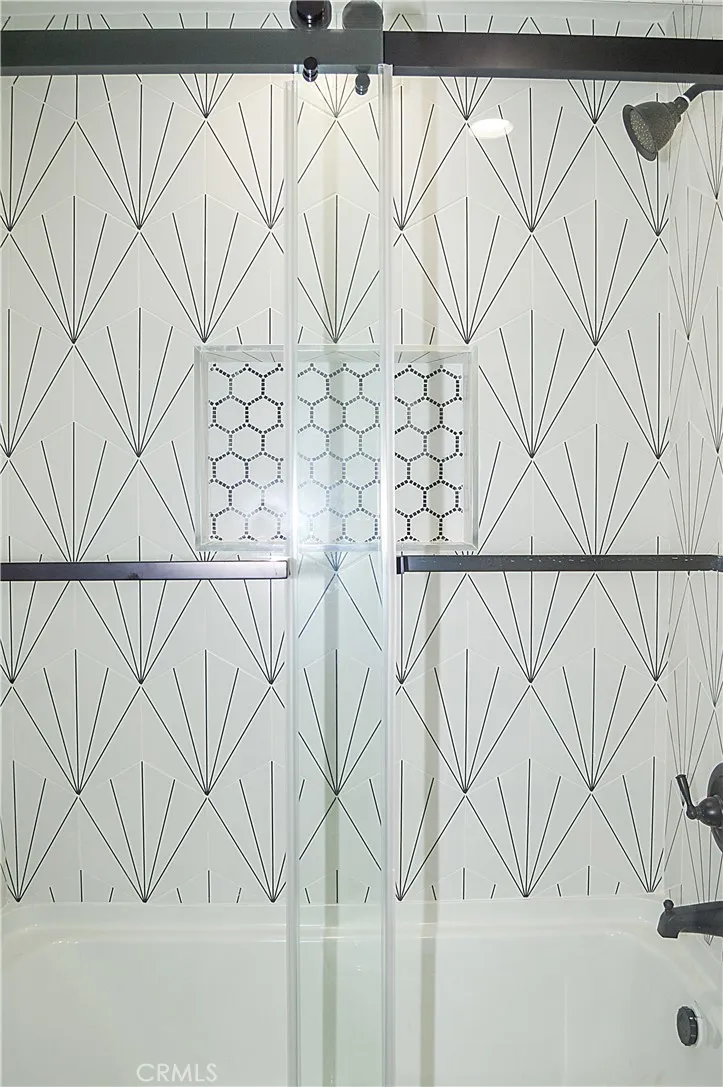 Unit 1 - Main Floor Bath with Glass Enclosed Tub/Shower Combo, Custom Tile, Lighted Mirror