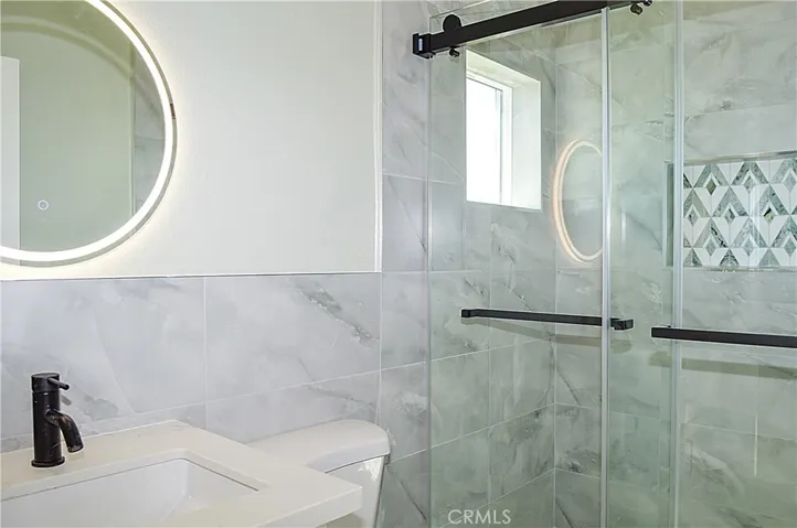 Unit 2 - Main Suite Bath with glass-enclosed shower, lighted mirror and even a view from the shower
