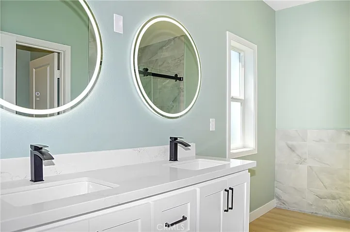 Unit 1 - Main Suite Bath with Dual Sinks, Lighted Mirrors, Walk-in Shower with Custom Tile, and Private Water Closet
