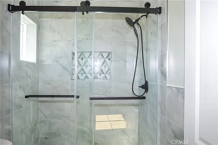 Unit 2 - Main Suite Bath with glass-enclosed shower, lighted mirror and even a view from the shower