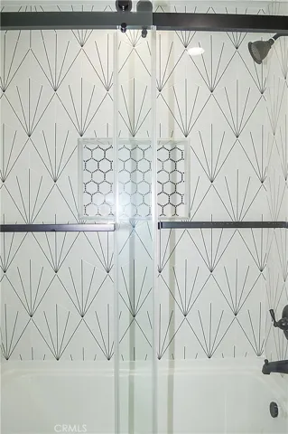 Unit 1 - Main Floor Bath with Glass Enclosed Tub/Shower Combo, Custom Tile, Lighted Mirror
