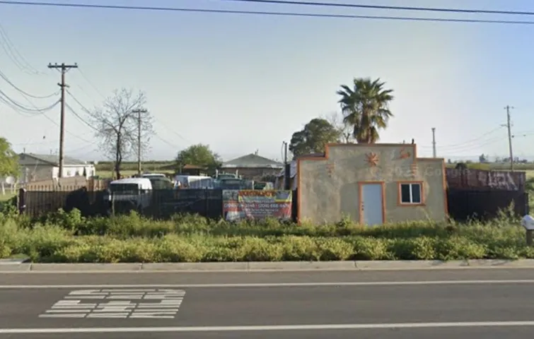 view of asphalt street with curbs
