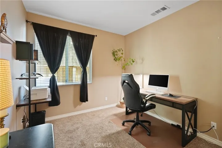 Versatile main-level bedroom or office.