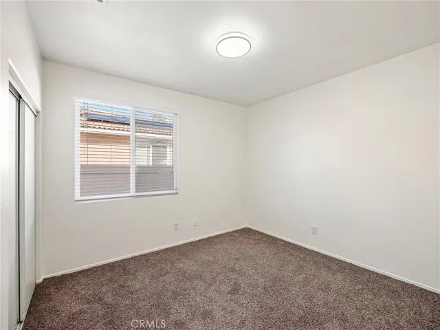 The second bedroom has been freshly updated with brand-new carpeting, fresh interior paint and a new light fixture, creating a bright and comfortable space ready for its next owner.