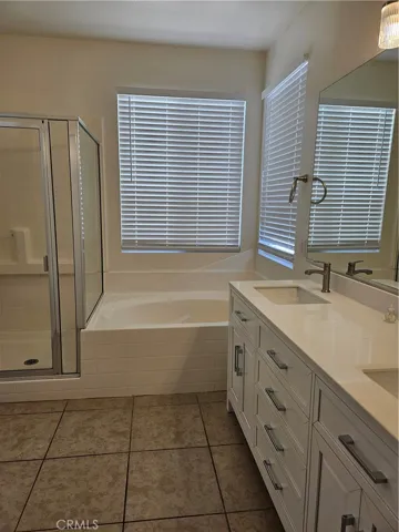 The master bedroom has a separate shower and tub, new cabinets