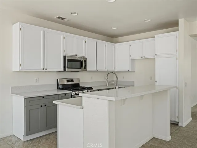 The beautifully upgraded kitchen features modern finishes and a fresh design, quartz counter tops, all new stainless steel appliances, freshly painted and tile flooring for easy maintenance.