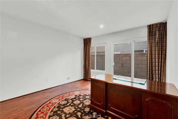 Downstairs bedroom and slider to backyard with double door closet backs to downstairs half bath