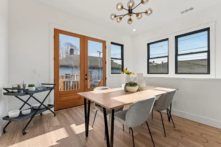 Dining area featuring a chandelier, light wood-style floors, and french doors
