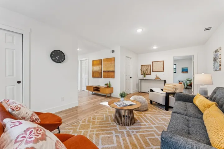 Living room featuring light wood-type flooring and recessed lighting