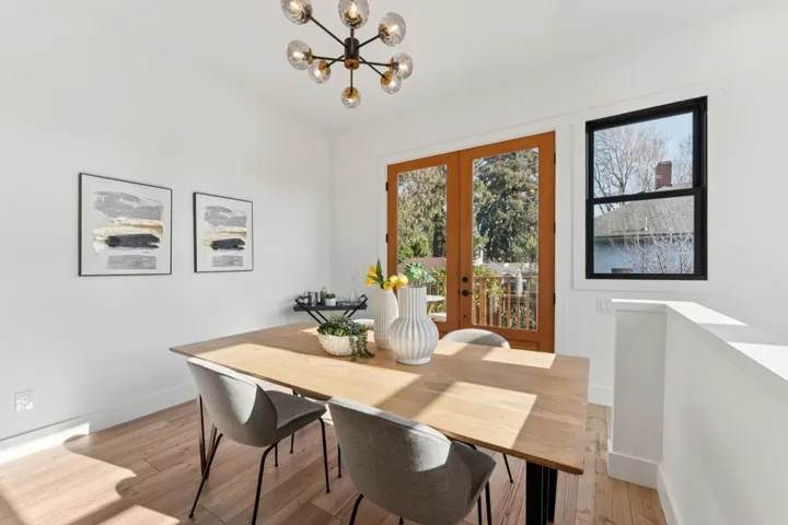 Dining space with french doors, a chandelier, and light wood-type flooring