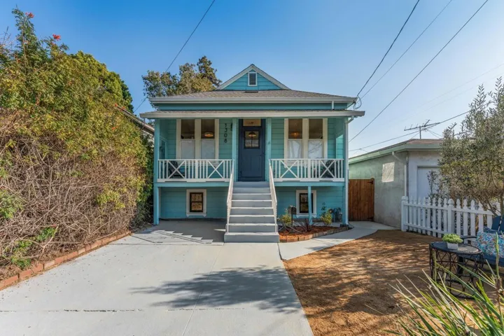 View of front facade with a porch and stairway