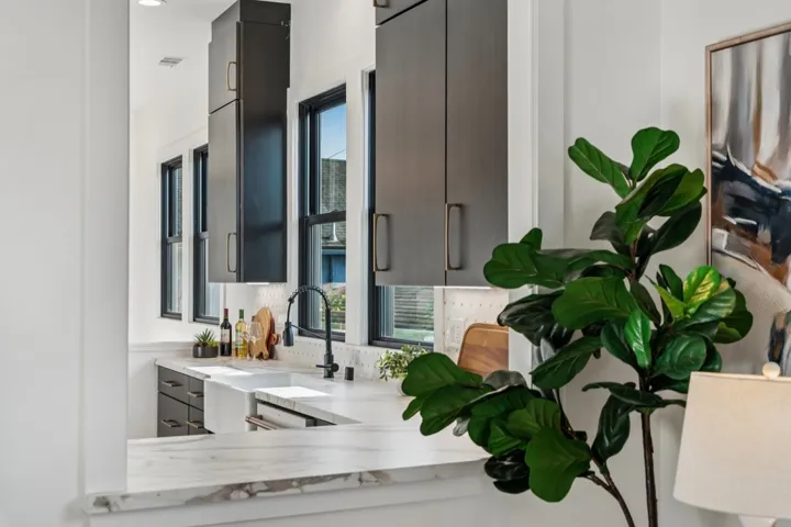 Kitchen featuring light countertops, healthy amount of natural light, and modern cabinets