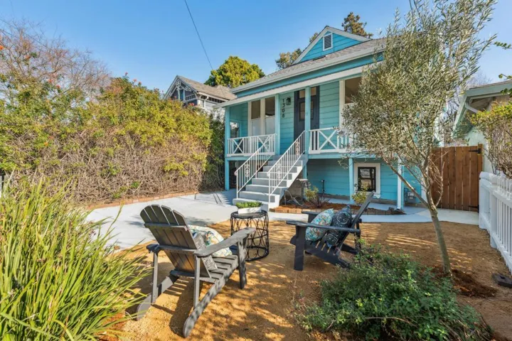 Rear view of house with a porch and a patio area