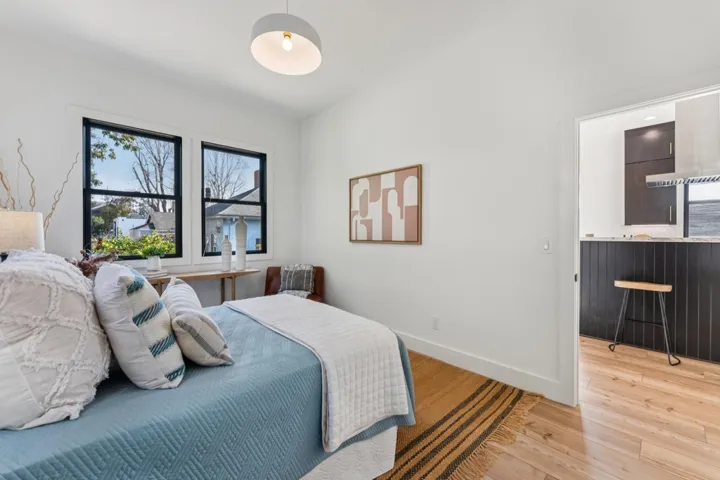 Bedroom with light wood-style floors and baseboards