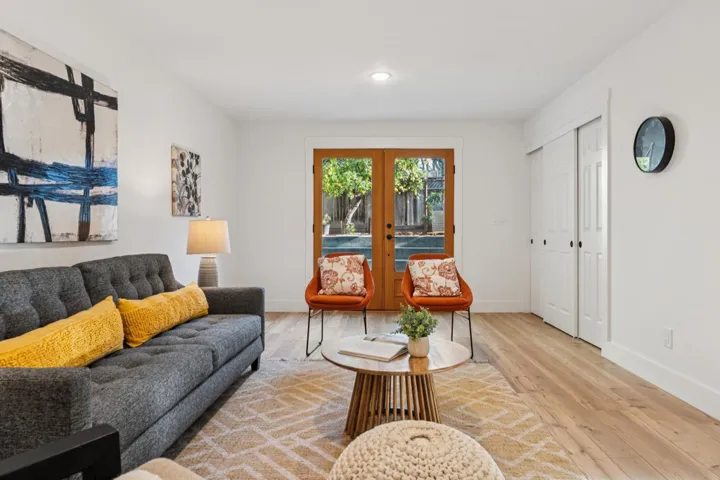 Living room with french doors and hardwood / wood-style flooring