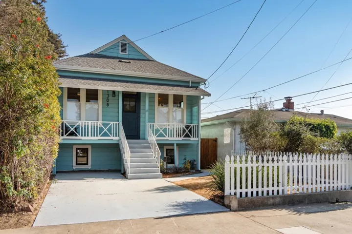View of front of property featuring a porch and a shingled roof