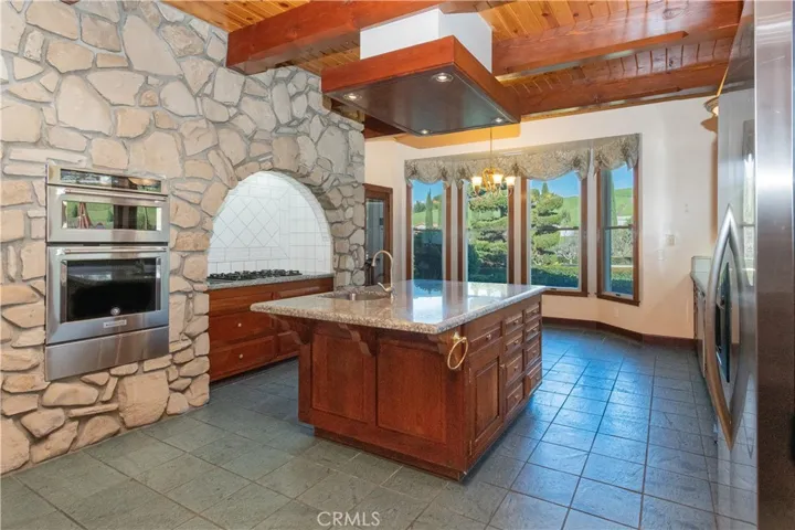 Looking into the cooking area with tile surround and native rock accent