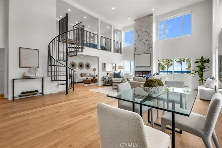 Dramatic 18-foot ceilings and expansive open living spaces create a grand, light-filled living room