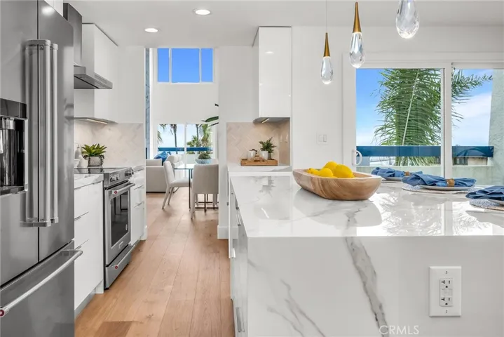 Beautifully designed kitchen with an oversized island, direct patio access, and inviting eat-in areas.