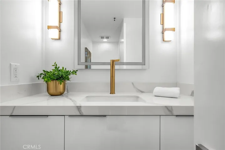 Designer guest bath with elevated fixtures, modern lighting, and sleek mirror features.