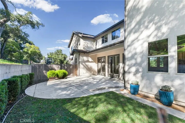 Backyard with patio and lawn.