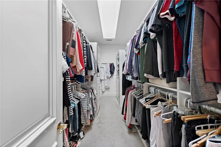 Spacious walk in closet that is light and bright!  You can actually see what you're doing!