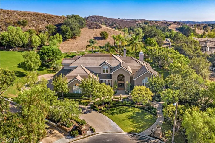 Commandingly positioned at the end of a secluded cul-de-sac.  The 4 car garage is down the driveway on the left side of the house.
