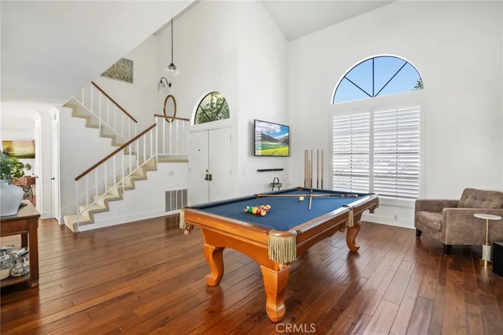Double doors lead to entry and formal living room currently used as game room.