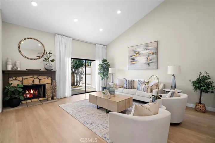 Soaring ceilings, recessed lighting, stone fireplace, slider to large private patio