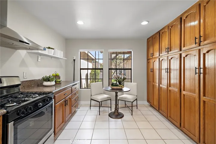 So rare to have this much space in a kitchen! Tons of cabinetry plus chic open shelving and a breakfast nook