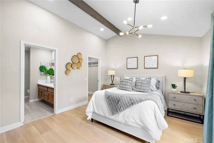 Primary suite has cathedral ceiling, walk-in closet, luxurious bathroom, sliders that open to the atrium patio