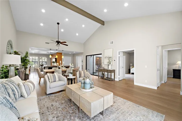 Living room, dining area, kitchen, cathedral ceiling, wide plank vinyl flooring