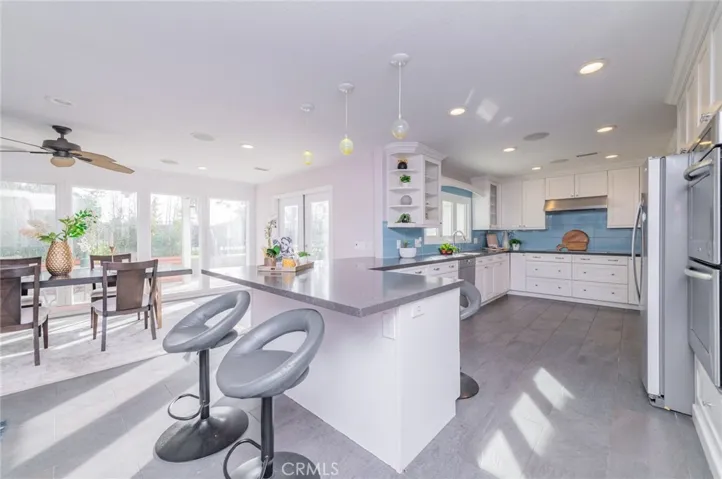 The dining area and kitchen enjoy abundant natural light throughout the day.