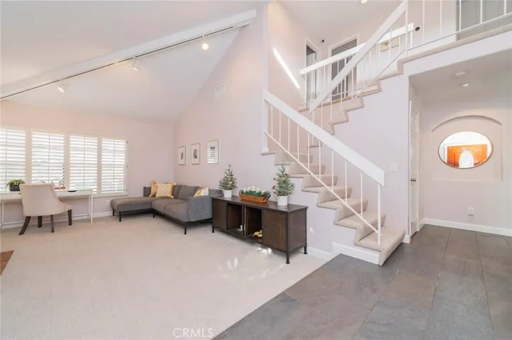 The living room features a vaulted ceiling and a fireplace, creating a warm and inviting atmosphere.