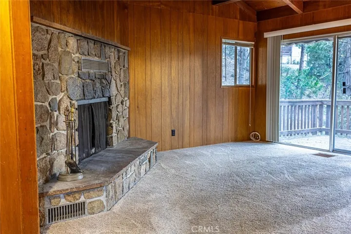 Main Level..
Living room with fireplace and slider door to deck..
